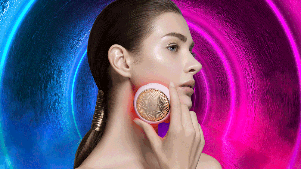 Summer skin care Brunette beauty model pink using FOREO UFO