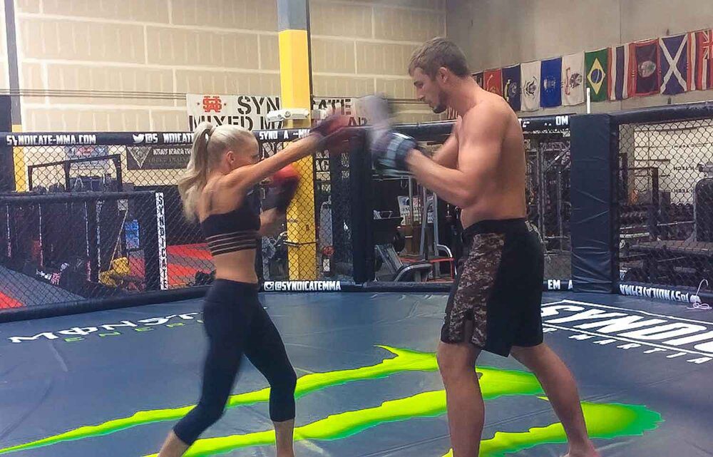 Pro MMA fighter in octagon training sparring Eve Dawes