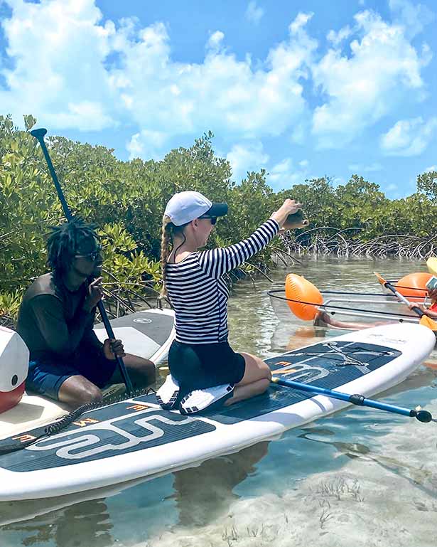 paddleboard tour mangroves Providenciales Eve Dawes holding conch