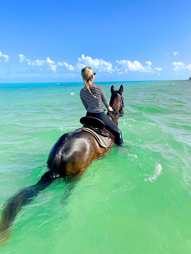 luxury travel blogger Eve Dawes horseback riding ocean Providenciales