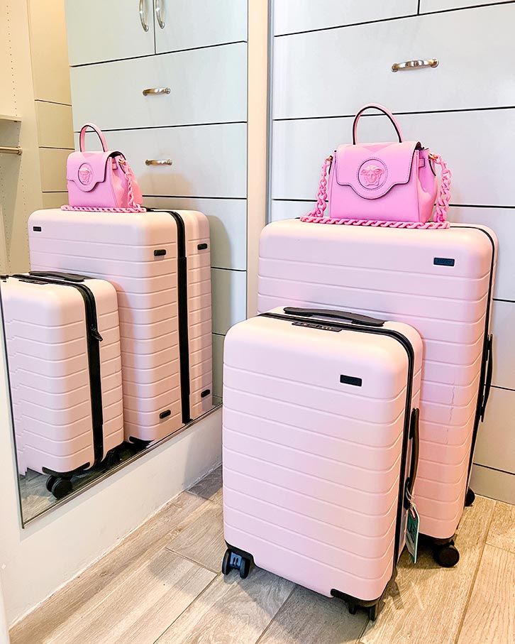 Away luggage pink carry on medium checked