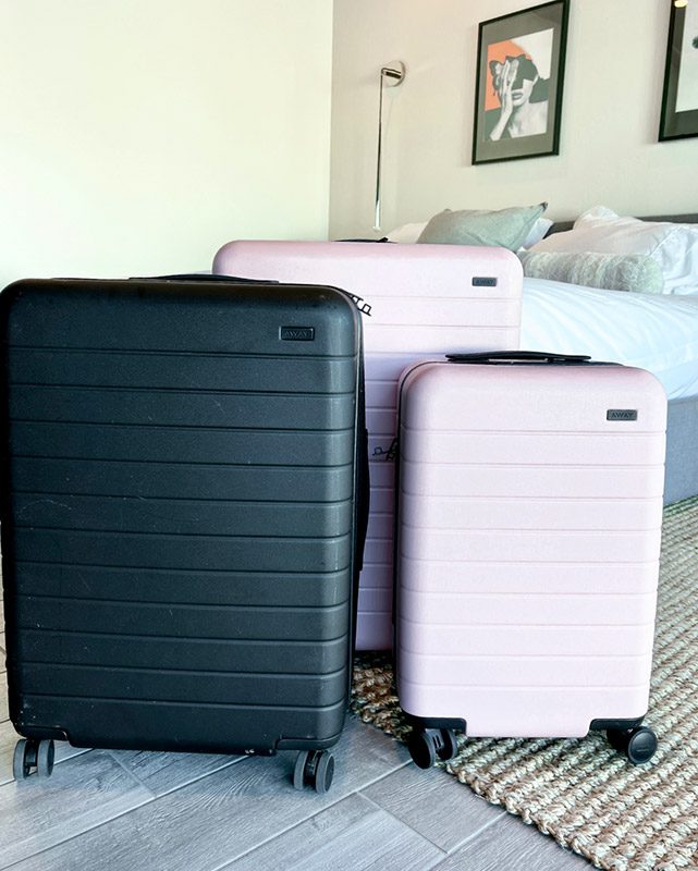 Away carry-on medium large checked luggage pink black flex