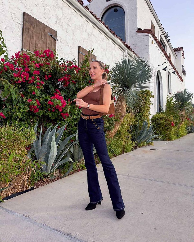 Pointed-toe black suede ankle boots with dark-wash flared jeans from Noli Shop