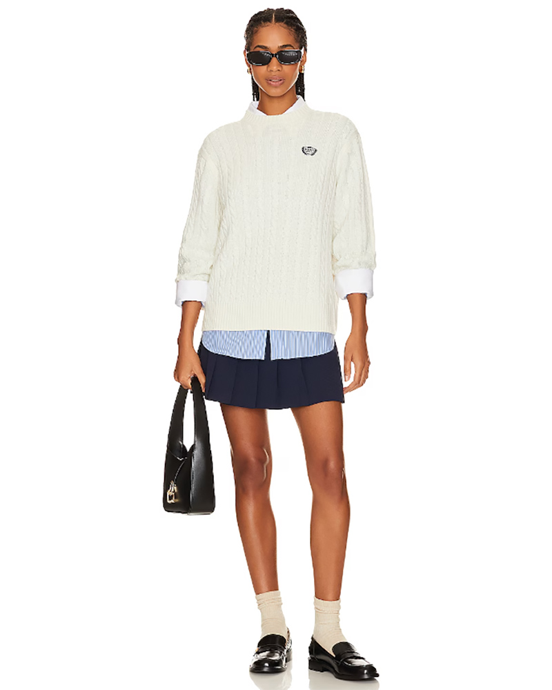preppy outfit idea cable knit sweater pleated mini skirt